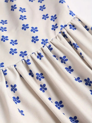 Cream midi dress with blue floral print and ruffled hem detail