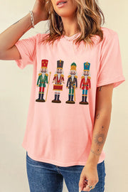 Blush pink t-shirt with a graphic print of four nutcracker soldiers in uniform.