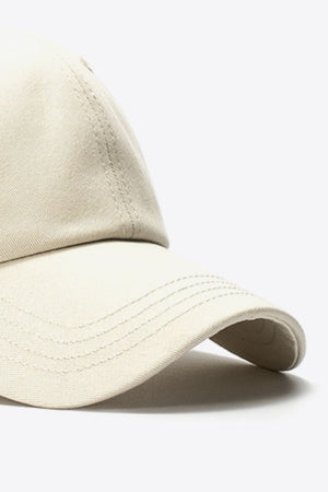 Beige cotton baseball cap with stitched details on the brim and crown.