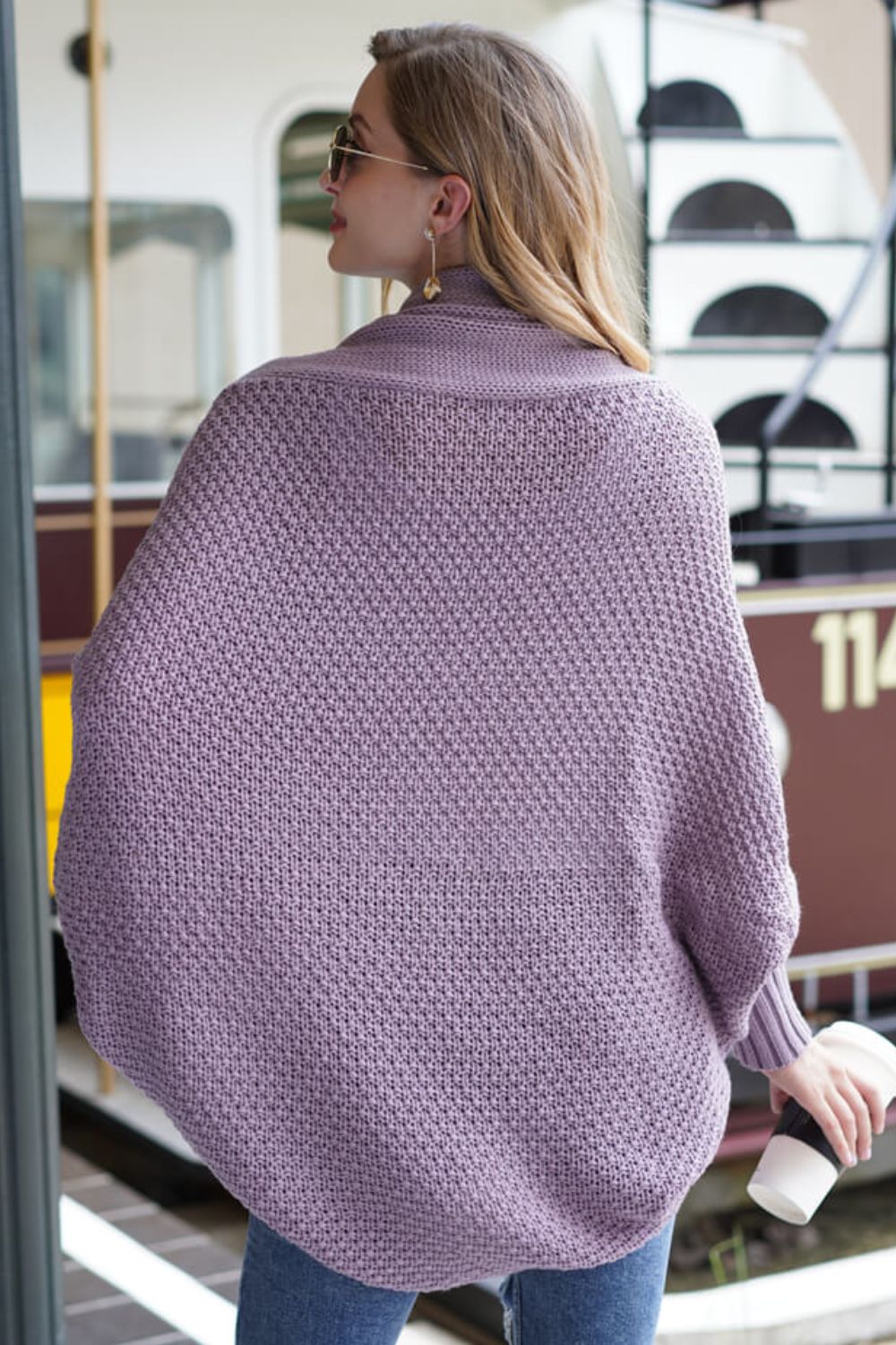 Purple batwing knit cardigan with a textured stitch and draped front.