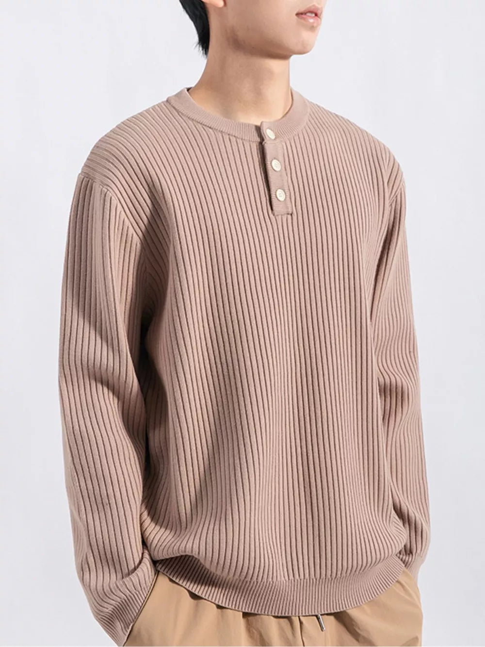 Men's ribbed knit top in apricot with button detail and crew neck.