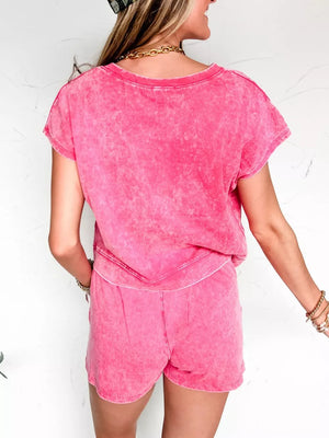 Pink acid wash two-piece set with round neck top and drawstring shorts.