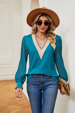Azure V-neck blouse with lace sleeves and ruffled cuffs, detailed neckline