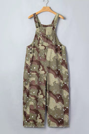 Cropped denim overalls in camouflage print with button details and distressed hem.