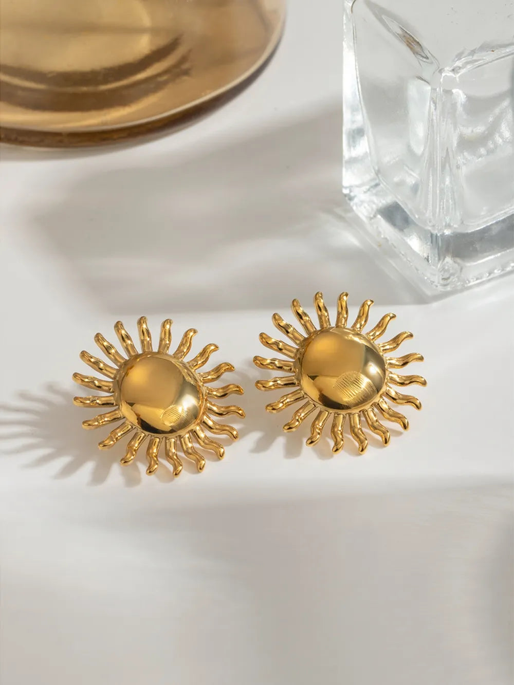 Gold sculptural sun stud earrings, 18K gold-plated.