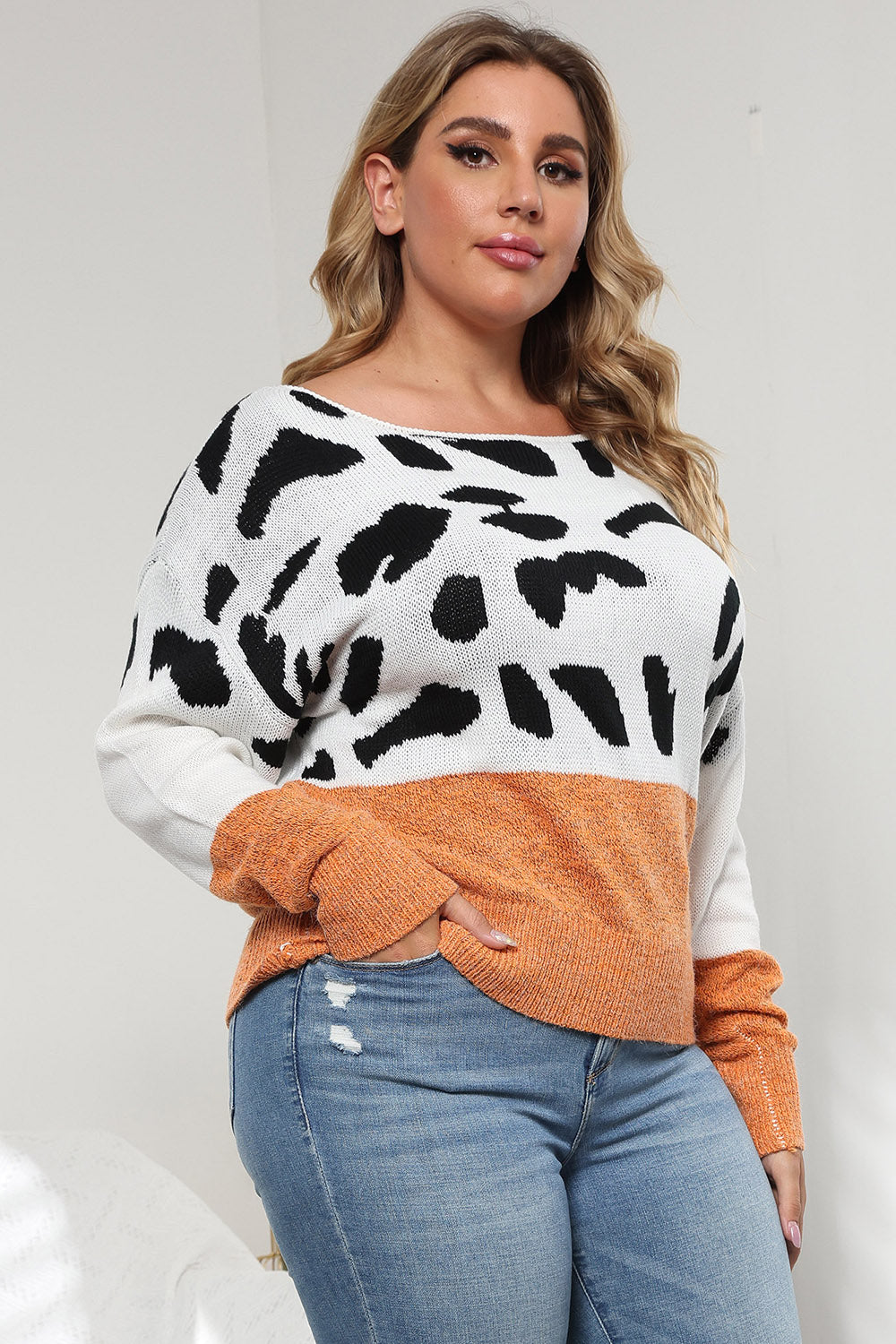 Dalmatian print colorblock knit sweater with crew neck and long sleeves.