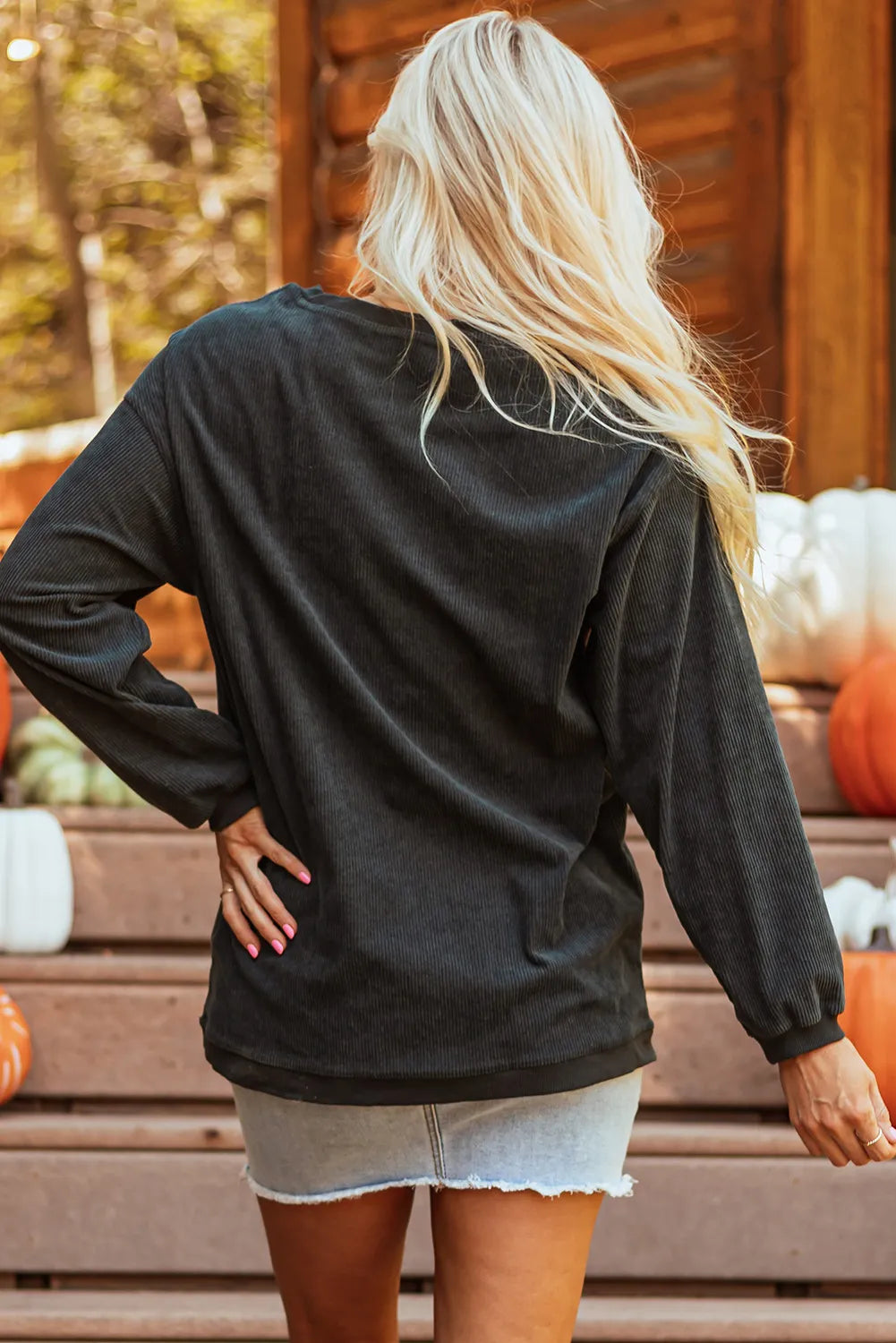 Textured corduroy sweatshirt in dark gray with long sleeves and ribbed cuffs.