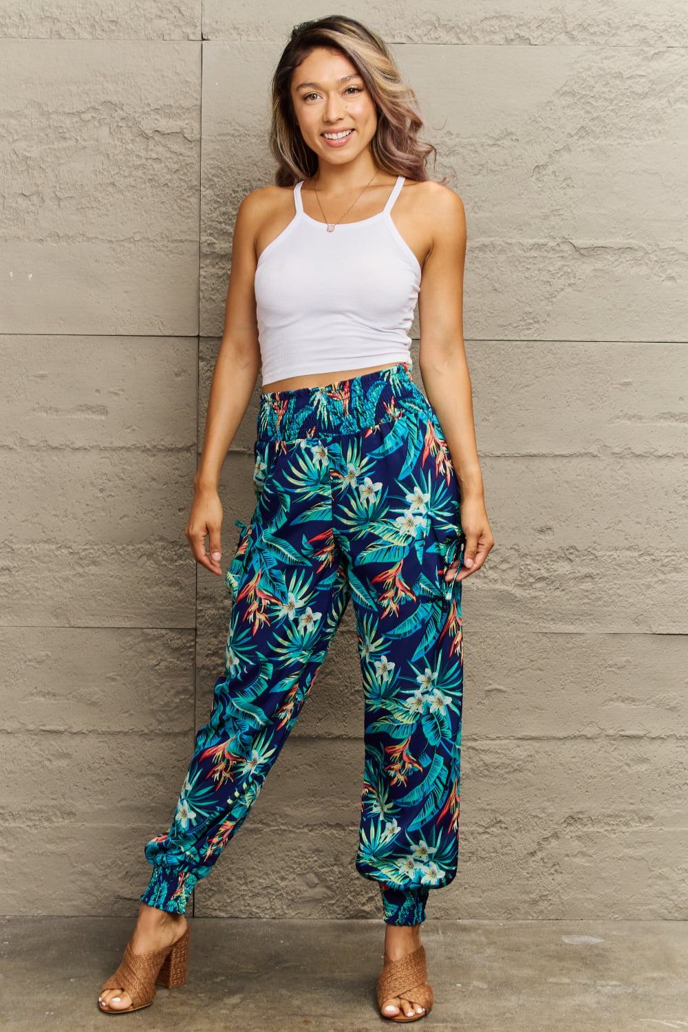 Tropical print cargo pants with gathered cuffs and pockets.