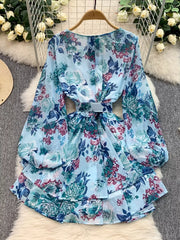 Light blue floral ruffle hem wrap mini dress with cinched waist and balloon sleeves.