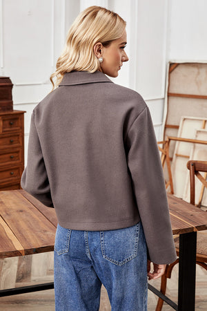 Mocha cropped wool-blend collarless jacket with buttoned front and lapel collar.