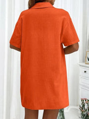 Orange linen shirt with short sleeves and collar, shown from the back.