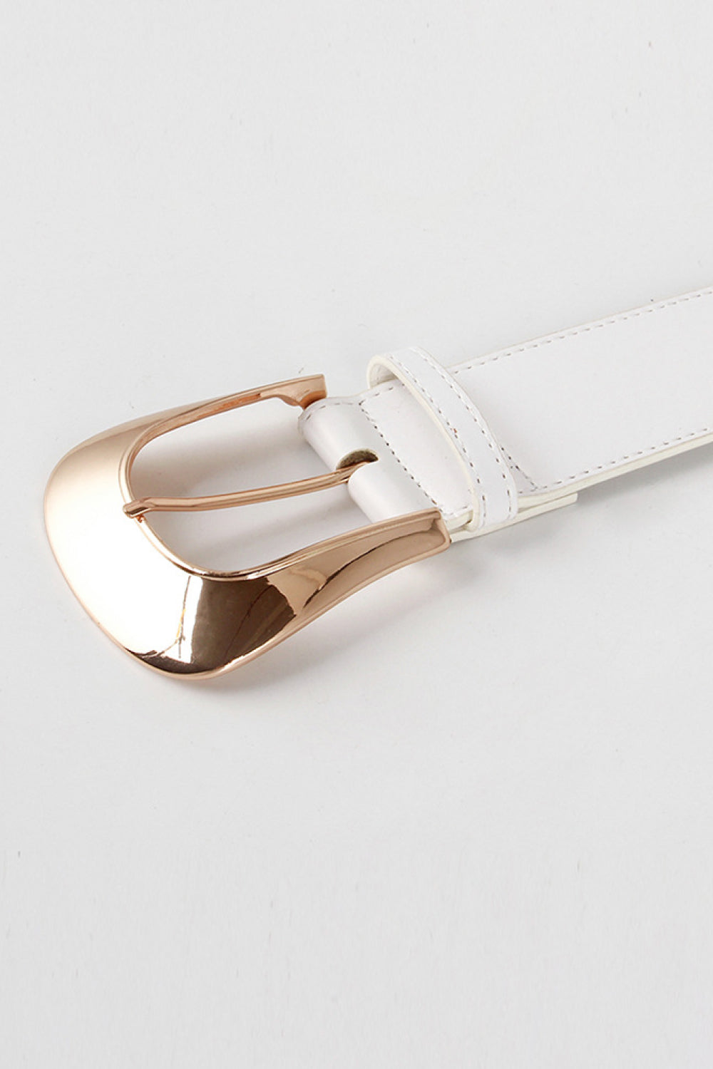 White leather belt with a sculpted rose gold buckle detail