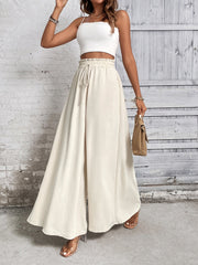 Beige ruffled waistline palazzo trousers with a drawstring waist and wide legs.