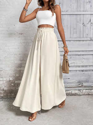 Beige ruffled waistline palazzo trousers with a drawstring waist and wide legs.
