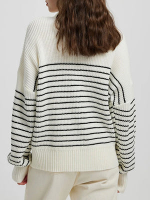 Cream ribbed knit sweater with black horizontal stripes and a half-zip neckline.