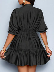 Black tiered mini dress with cinched waist and ruffled puff sleeves.