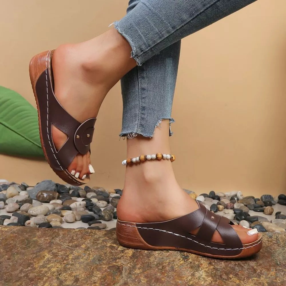 Brown embellished open-toe wedge sandals with decorative straps and contrast stitching.