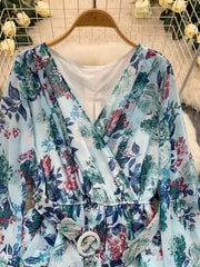 Light blue floral wrap mini dress with V-neck, cinched waist, and belt.