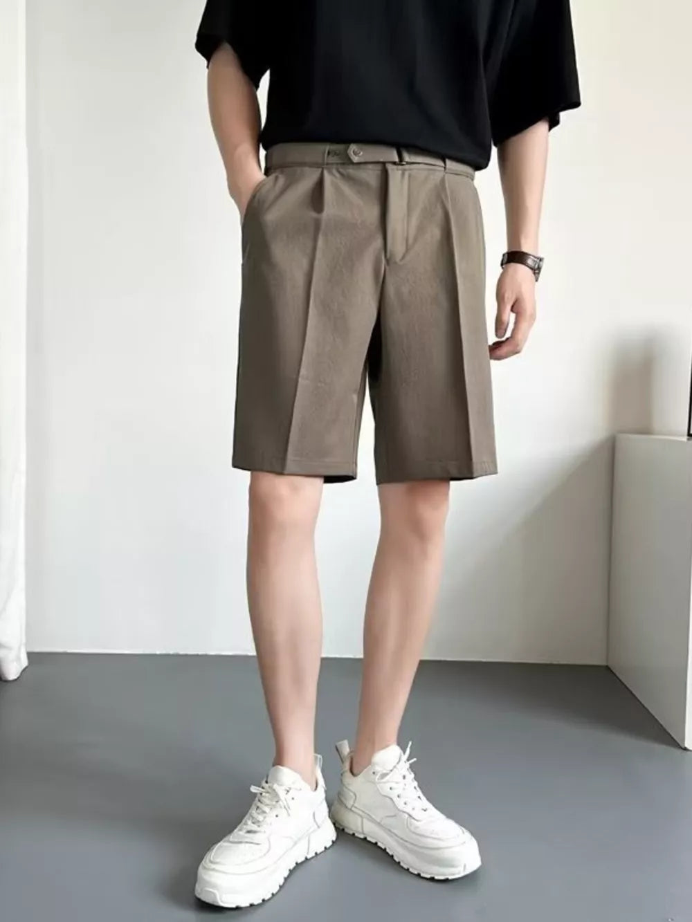 Belted pleated chino shorts in mocha color with a relaxed fit.