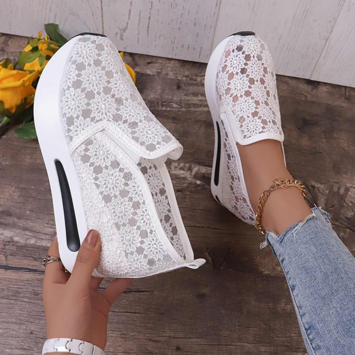 White floral lace slip-on sneakers with a chunky sole and breathable design.