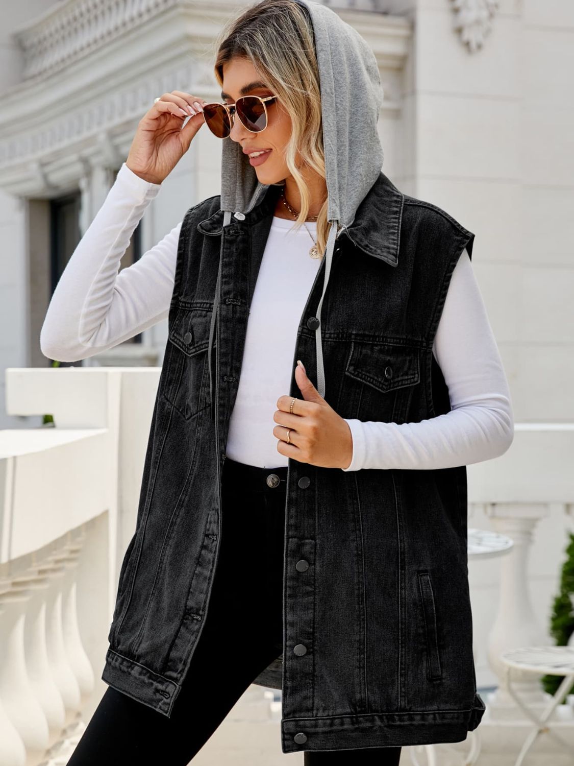 Dark denim hooded vest with contrast lining and button front, worn by a woman.
