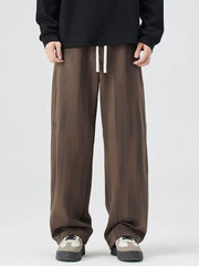 Brown jogger sweatpants with drawstring waist and relaxed fit.