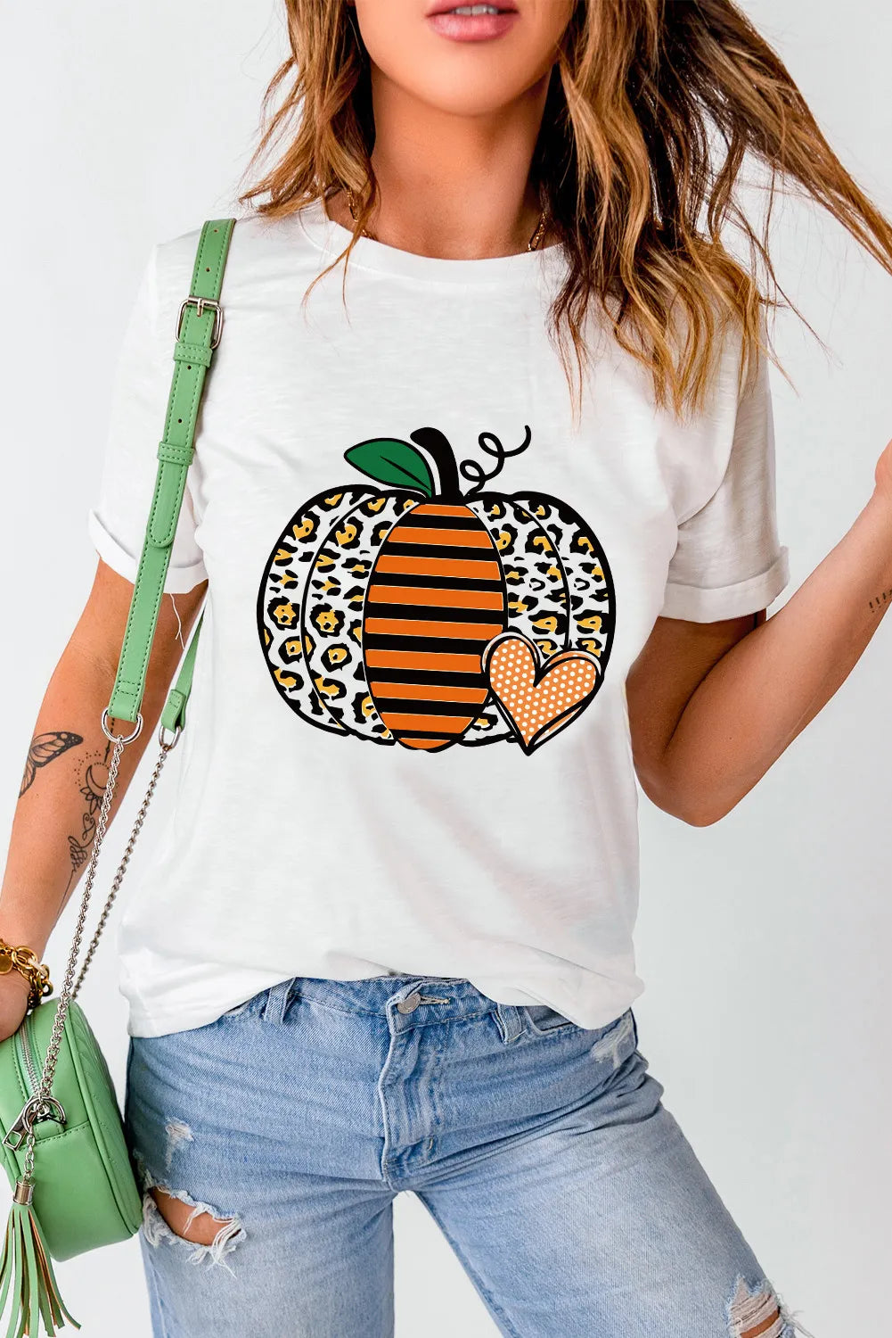 White t-shirt with a leopard print pumpkin graphic and orange stripes.