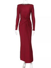Red long sleeve maxi dress with ruched knot detail and boat neckline.