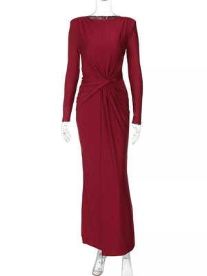 Red long sleeve maxi dress with ruched knot detail and boat neckline.