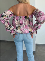 Off-the-shoulder blouse with romantic floral print and ruffle sleeves, in blush pink.