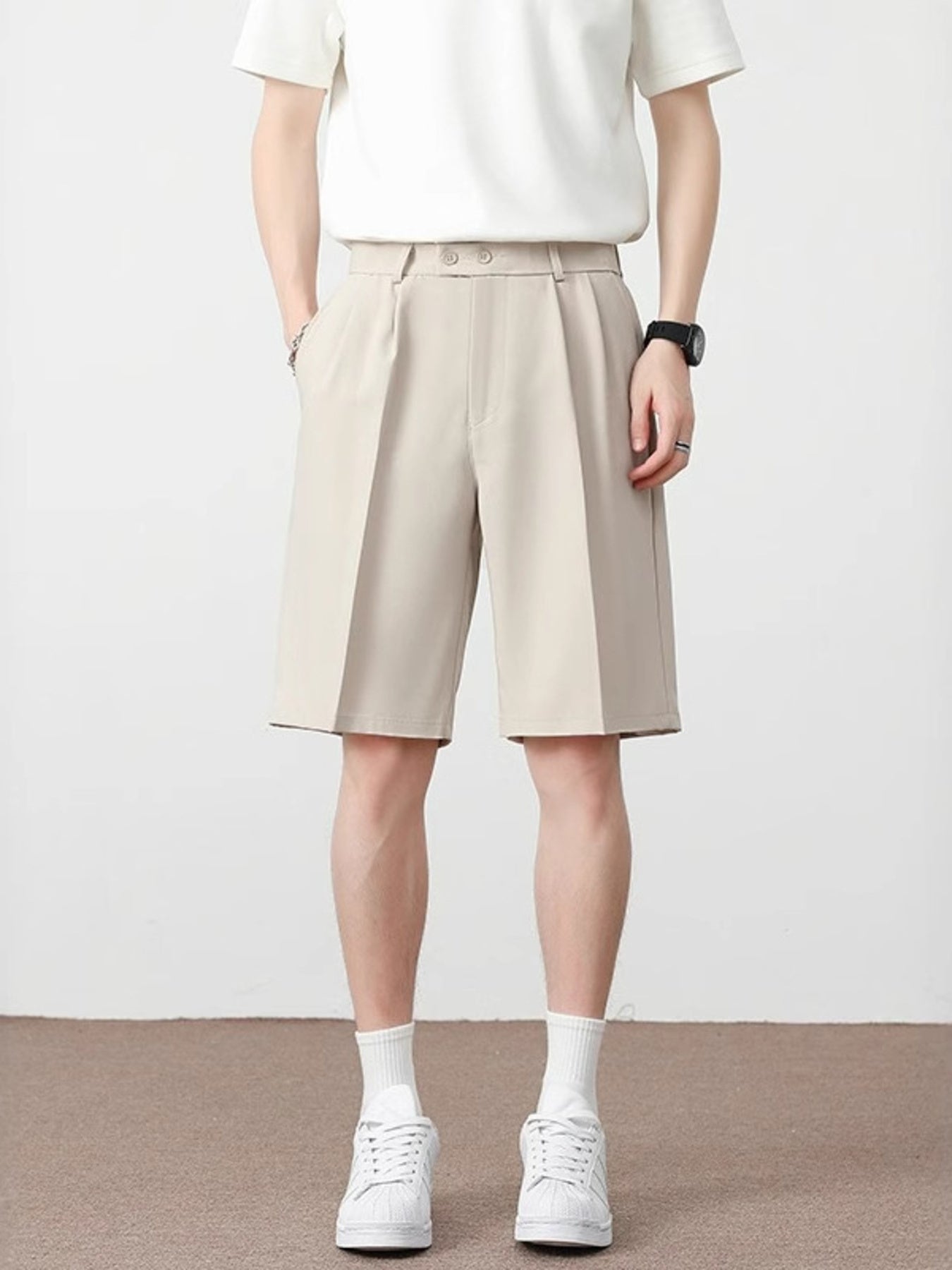 Cream pleated detail loose-fit chino shorts with a double button waist.