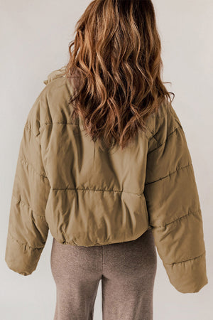 Taupe cropped puffer jacket with hood collar and horizontal quilting detail.