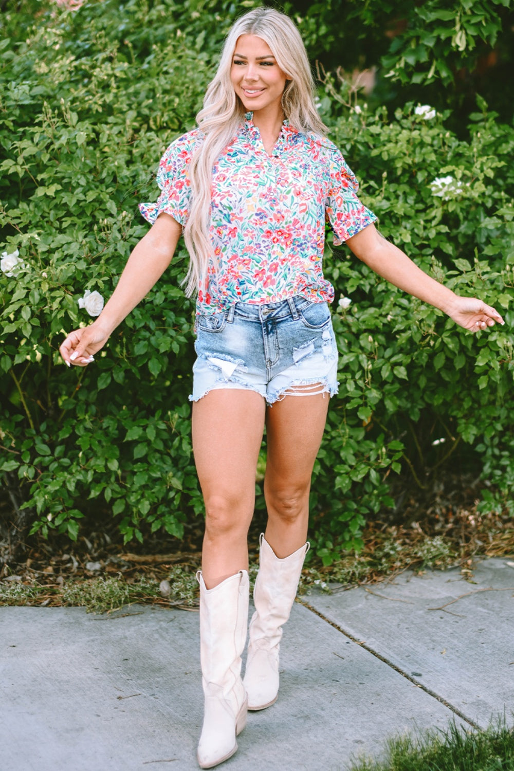 Floral ruffle collar puff sleeve blouse with a vibrant floral print and short sleeves.
