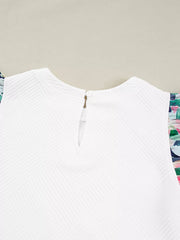 White geometric knit top with floral ruffled sleeves and button back closure.