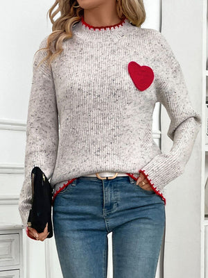 Light gray ribbed knit sweater with red heart appliqué and trim.
