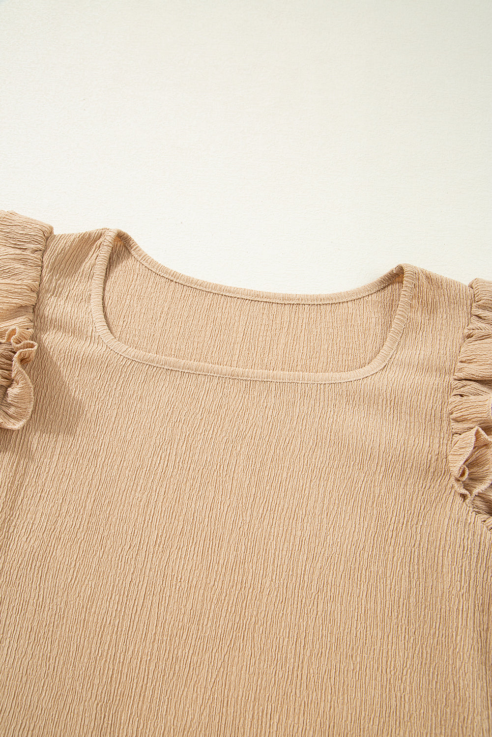Tan textured square neck blouse with ruffled short sleeves