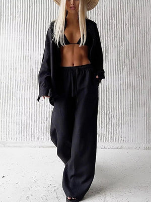 Black relaxed fit two-piece set with button-up shirt and wide-leg pants.