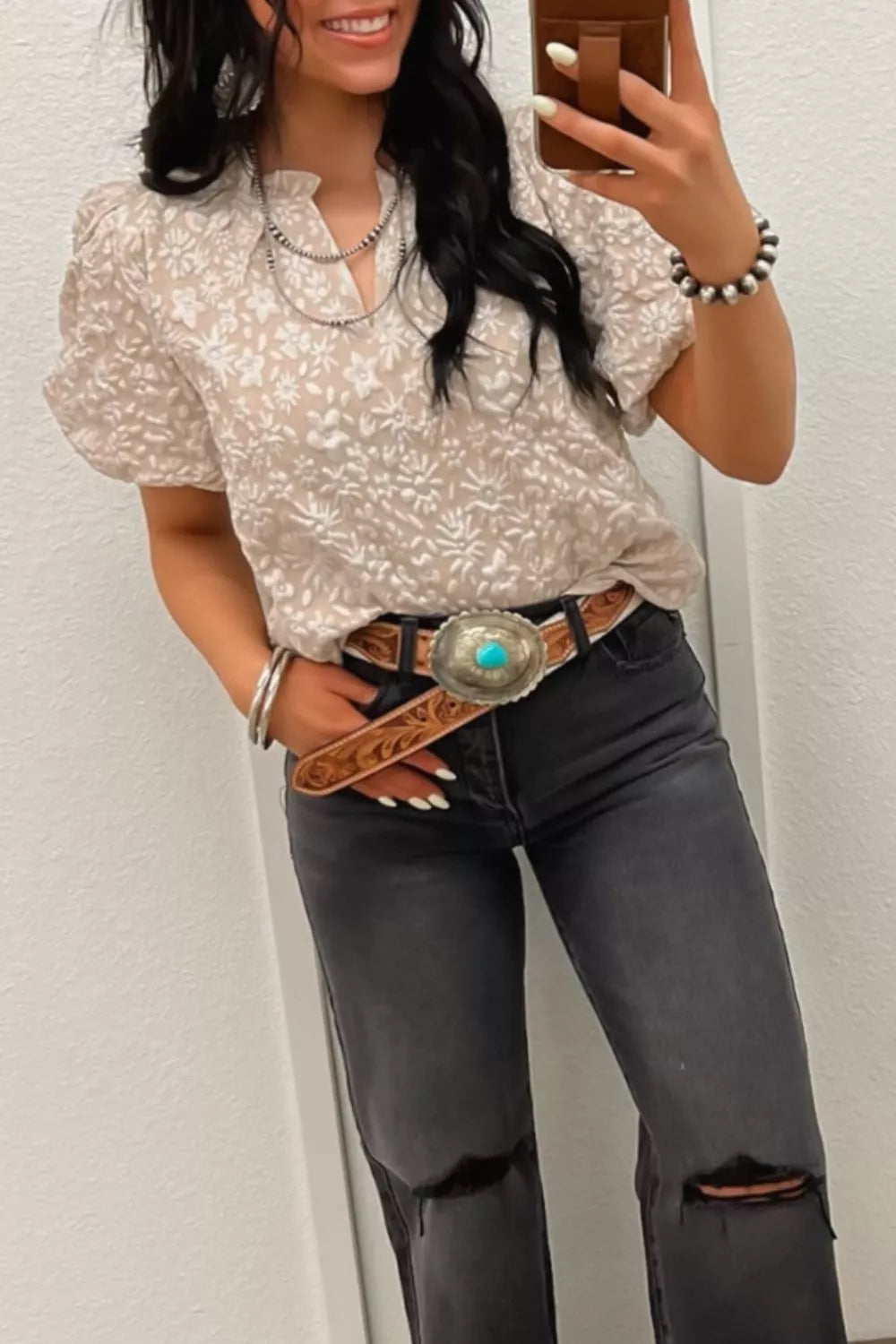 Charming floral jacquard shirt with puff sleeves and a frill neckline, worn with grey ripped jeans.