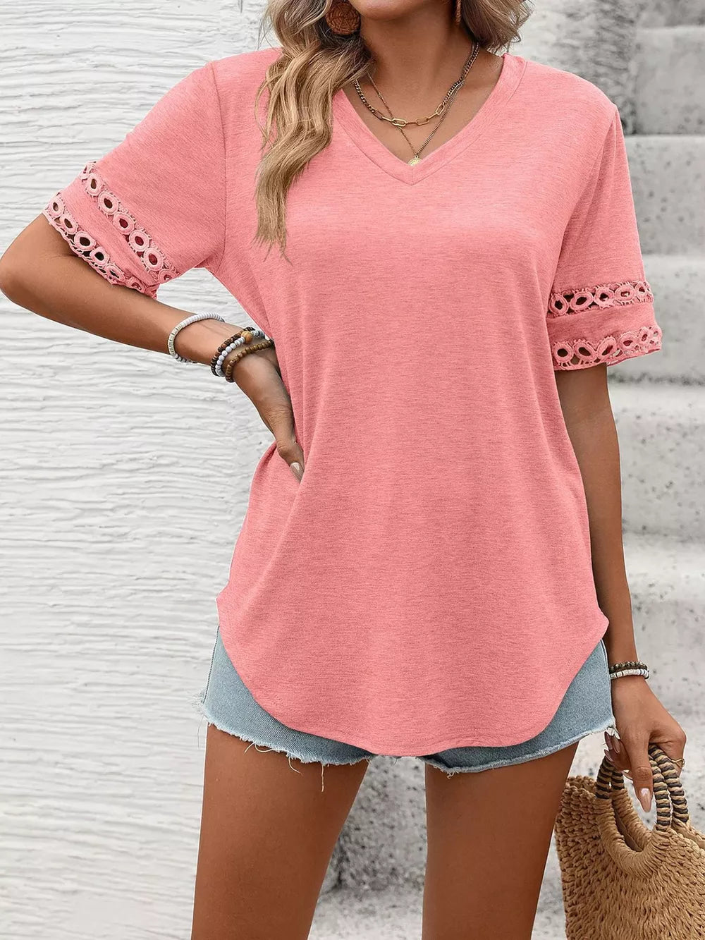 Pink V-neck t-shirt with lace trim on short sleeves.