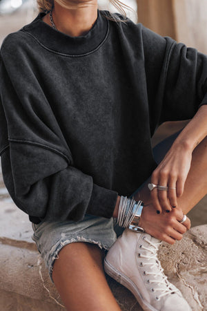 Acid wash mock neck sweatshirt in black with ribbed cuffs and neckline.