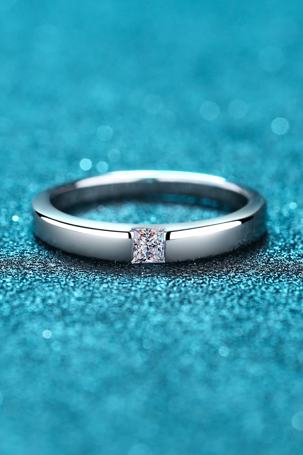 Silver band ring with a square-cut solitaire diamond accent