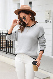 Light gray acrylic crewneck sweater with contrast black trim on neckline, cuffs, and hem.