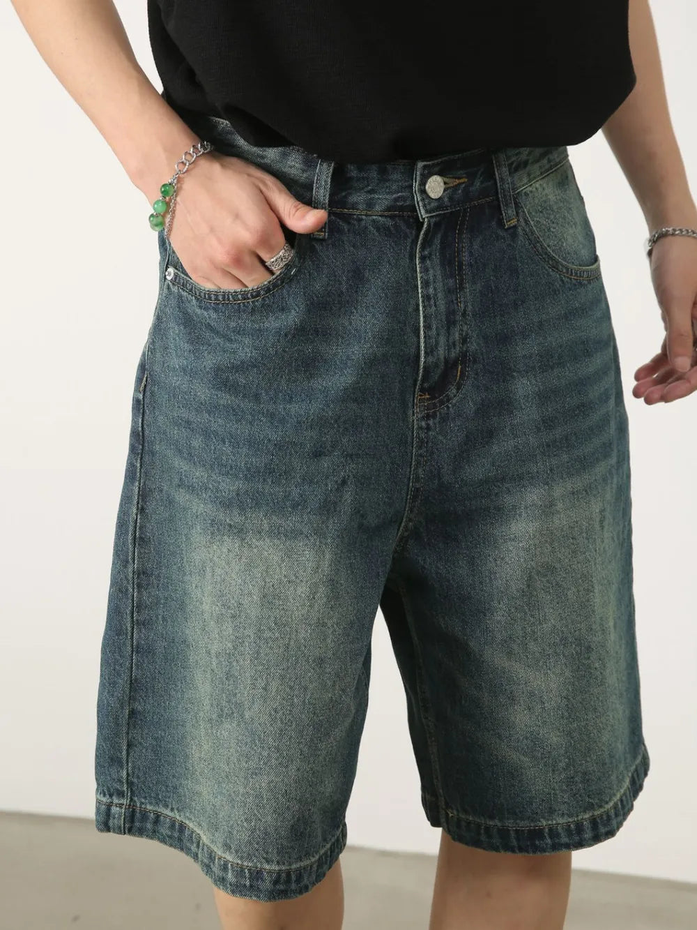 Baggy denim bermuda shorts in light blue with washed effect and button closure.