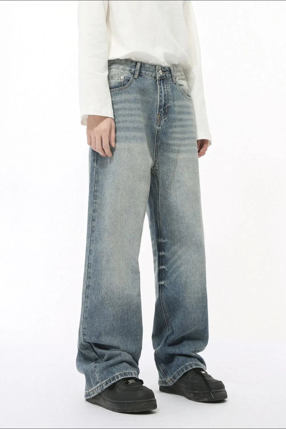 Oversized baggy wash denim trousers in medium blue with a relaxed fit and wide leg.