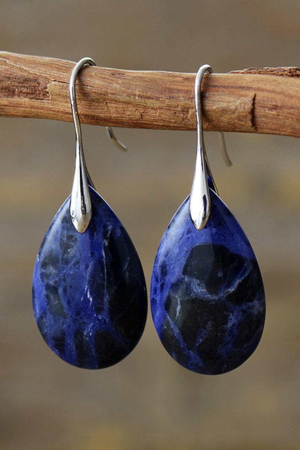 Sapphire stone dangle earrings with silver hooks and gold accents.