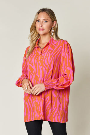 Orange and pink zebra print blouse with shirred cuffs and collar