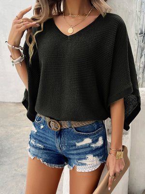 Black open-knit dolman sleeve v-neck sweater with textured ribbing.