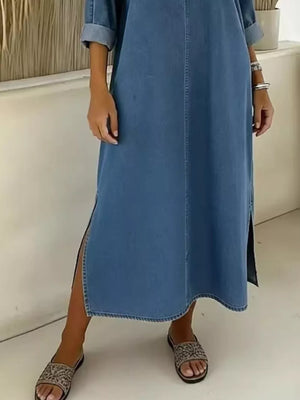 Light blue denim midi dress with V-neck, cuffed sleeves, and side slit.