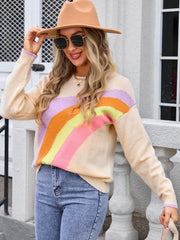 Apricot crewneck knit sweater with pastel rainbow stripes and lilac cuffs.