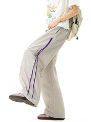 Men's loose-fit casual sweatpants in mocha with purple zipper detail and drawstring.